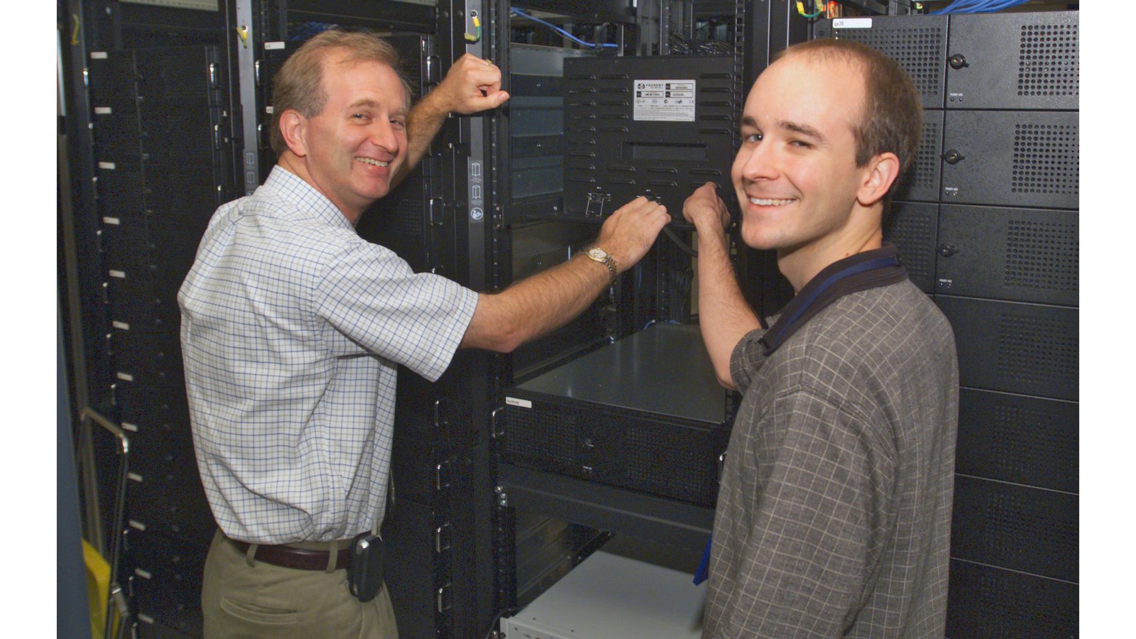 Two NASA engineers performing a networking check in a computer server room