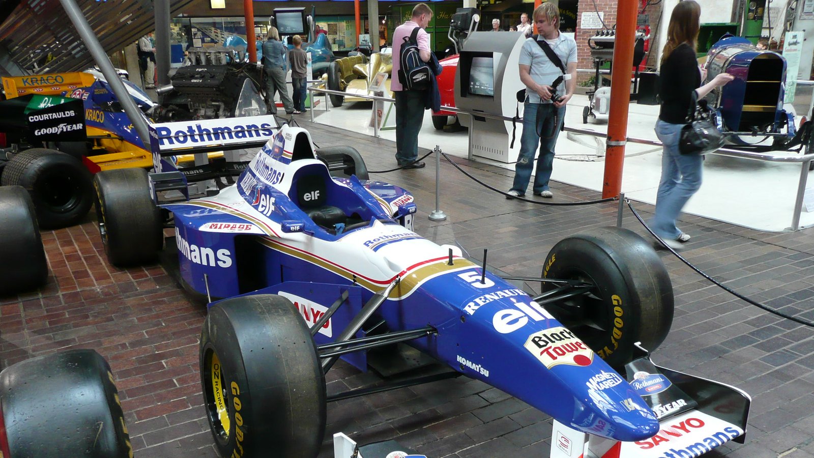 A restored 1996 Williams-Renault FW18 Formula 1 car displayed in a museum.