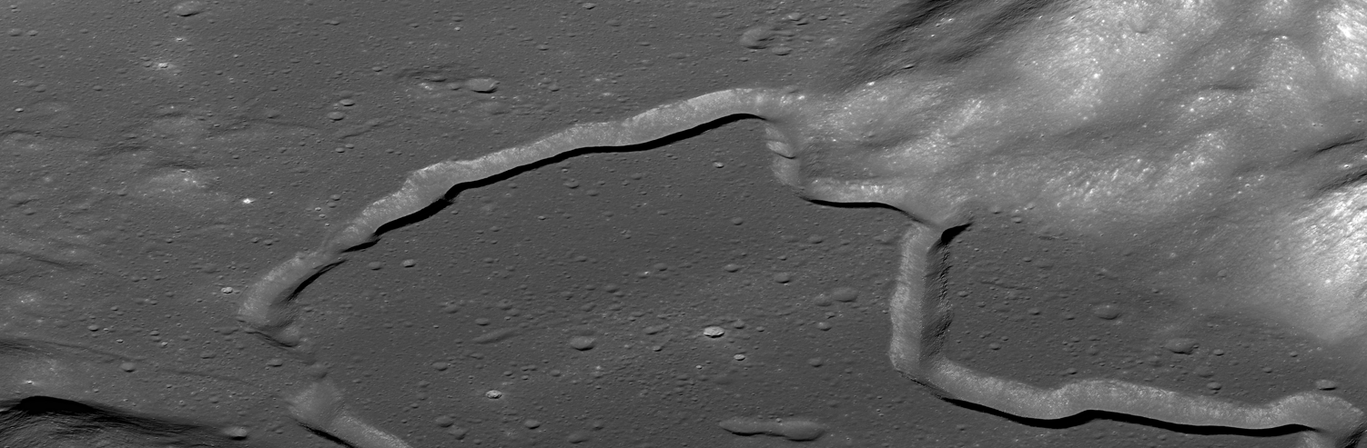 Archival orbital photograph of the winding Hadley Rille and cratered lunar terrain